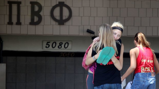 Students console each other outside of the Pi Beta Phi sorority near San Diego State University after news that a student had died at the Phi Kappa Theta fraternity on campus in April 2012.