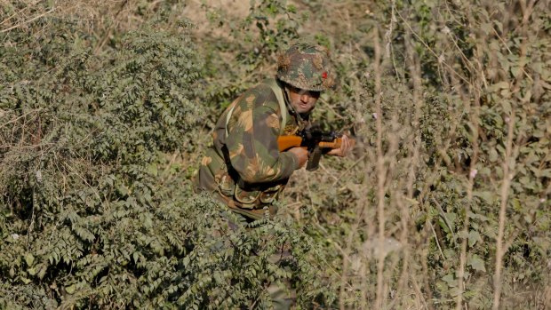 An Indian army soldier is seen search a forest area outside the Pathankot air force base on Sunday.