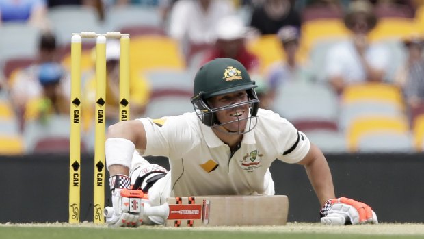 Australia's David Warner falls down after playing a shot during play on day one of the first Test.
