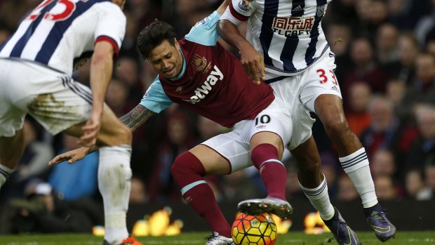 Scrapping: West Ham United's  Mauro Zarate battles for the ball during the English Premier League match at Upton Park against West Brom.