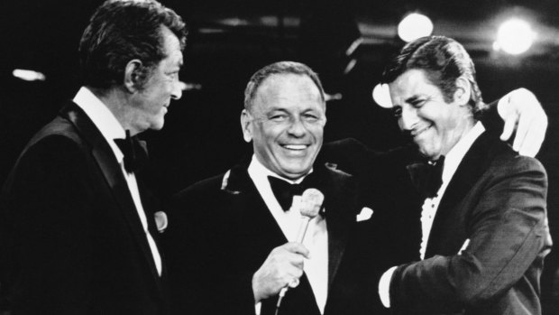 Frank Sinatra, centre, appearing at the annual Muscular Dystrophy telethon hosted by Jerry Lewis, right, brings on Dean Martin.