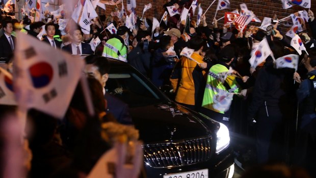 A vehicle carrying former South Korean President Park Geun-hye arrives at her own home on March 12.