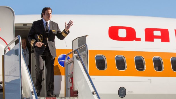 John Travolta arrives for the unveiling of Qantas' new retro-designed Boeing 737-800 during a rollout at the Boeing Field in Seattle, Washington in 2014.