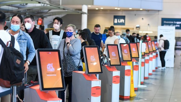 Passengers queue at Sydney Airport on Wednesday.