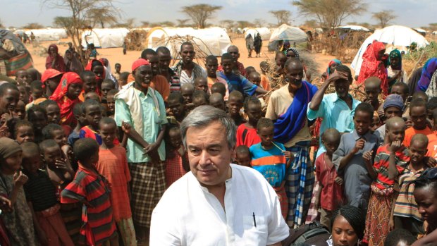 Then UN High Commissioner for Refugees Antonio Guterres is surrounded by Somali refugees in 2011.
