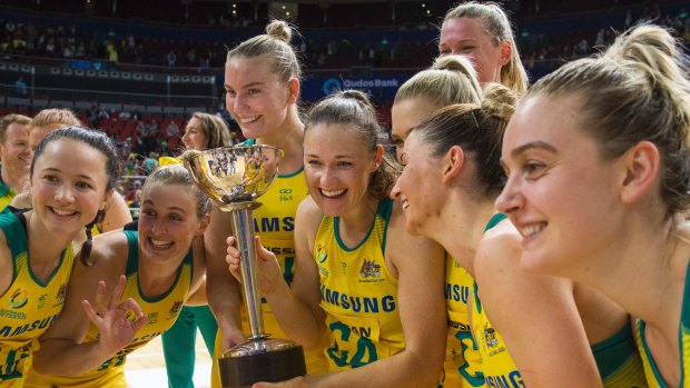 The victory spoils: Australian Diamonds pose with the trophy.
