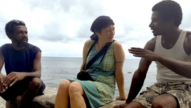 Writer Janet Galbraith talks to islanders in a scene from the film 