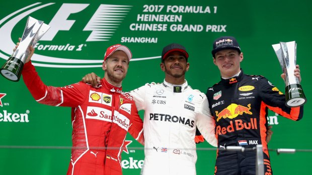 Leading lights: Race winner Lewis Hamilton with second placed Sebastian Vettel (left) and third placed Max Verstappen.