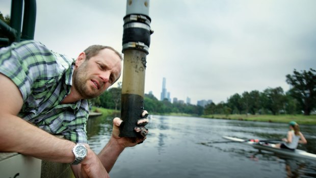 Dr Perran Cook taking a mud sample that contains the bacteria.