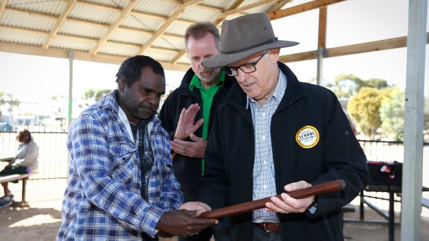 Prime Minister Malcolm Turnbull and Indigenous Affairs Minister Nigel Scullion receive gifts after a visit to the Yalata Anangu School  in South Australia.