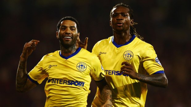 Singapore in sight: Jermaine Pennant (left) is being sized up by Tampines Rovers.