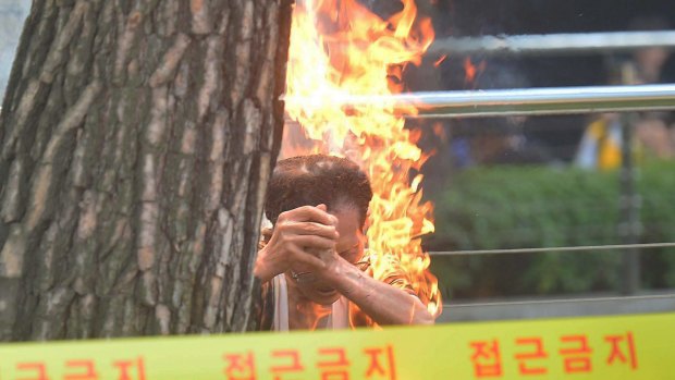 South Korean man Choi Hyun-yeol, 80, sets himself on fire in front of the Japanese embassy on Wednesday in Seoul, South Korea.