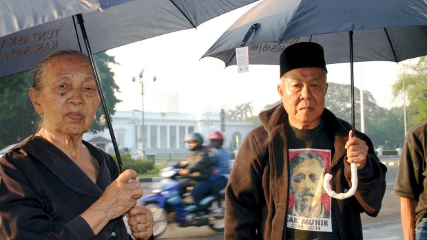 Sumini, left, and Anwar Umar, victims of the 1965-66 anti-communist crackdown, protesting outside the presidential palace in Jakarta.
