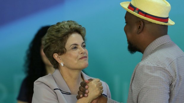 Brazilian President Dilma Rousseff, left, greets Brazilian rapper Big Richard, during a meeting with Brazilian artists and intellectuals who support the government in Brasilia on Thursday.