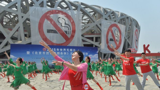 People dance to popularise anti-smoking measures at the national stadium, better known as "the Bird's Nest", in Beijing. 