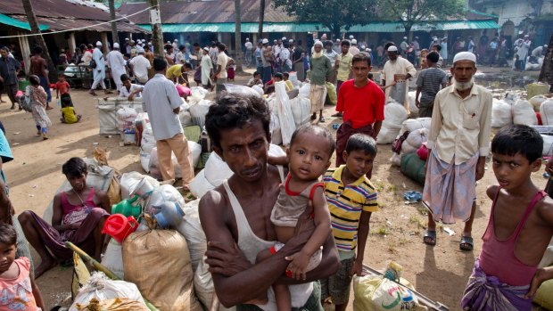 Newly arrived Rohingya Muslims from Myanmar prepare to leave a transit shelter in Shahparirdwip, Bangladesh.