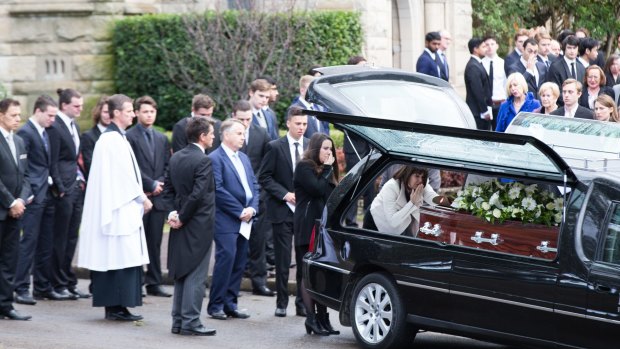 Kathy Kelly blows a kiss to her son at his funeral at The Kings School in Parramatta.