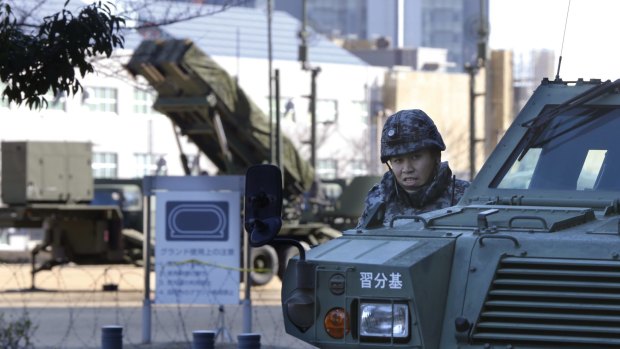 A member of the Japan Self-Defence Forces stands near a Patriot missile unit deployed for North Korea's rocket launch in Tokyo.