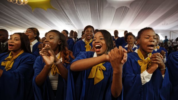 The choir sings at the student graduation ceremony attended by Zimbabwean President Robert Mugabe.