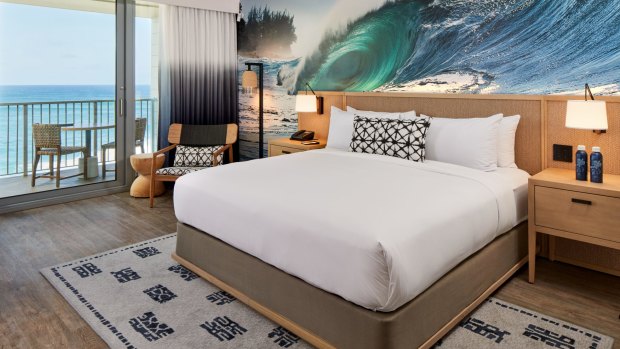 The guest room transformations include a vast surf image plastered along a wall (the photography comes from North Shore artists), ombre curtains, neutral textiles and floorboards.