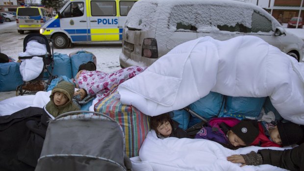 Children from Syria sleep outside the Swedish Migration Board in Marsta, Sweden, in January.