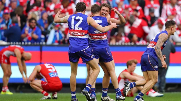 Worth the wait: The Bulldogs celebrate at the final siren.