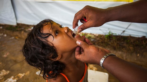 A Rohingya girl is administered cholera vaccine at the Balukhali makeshift camp in Cox's Bazar, Bangladesh.