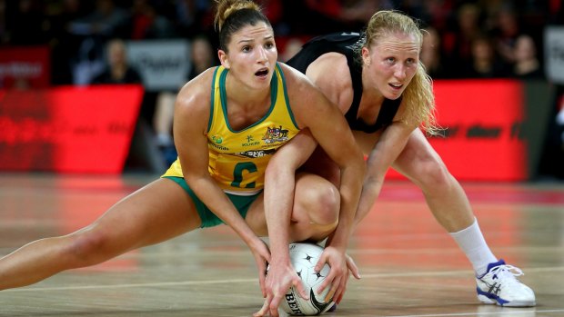 AUCKLAND, NEW ZEALAND - SEPTEMBER 19: Kim Ravaillion of the Diamonds and Laura Langman hold onto the ball  during game two of the Constellation Series between the New Zealand Silver Ferns and the Australian Diamonds at the Vector Arena on September 19, 2013 in Auckland, New Zealand.  (Photo by Phil Walter/Getty Images)