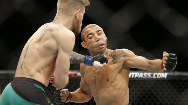 McGregor sends Jose Aldo to the floor in December 2015.