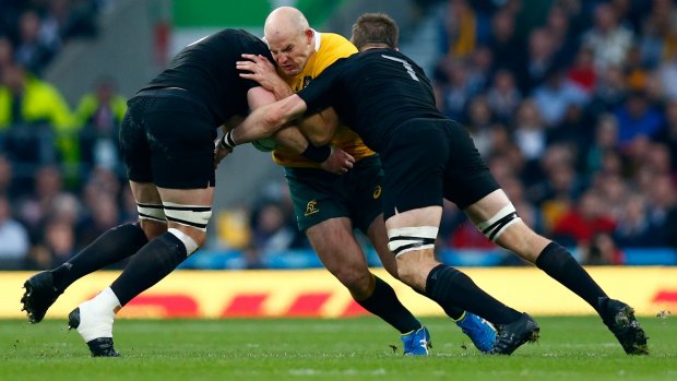 Captain crunched: Stephen Moore is tackled by Richie McCaw and Kieran Read.