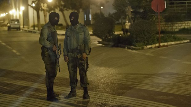 Masked Tunisian soldiers stand guard outside the National Bardo Museum following the attack.