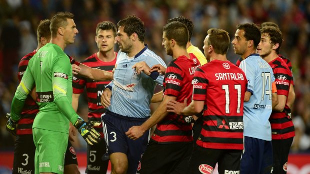 Tempers fray: Sydney FC and Wanderers players scuffle during the derby last October.