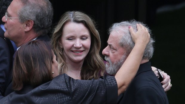 Senators Fatima Bezerra, left front, and Vanessa Graziotin embrace Mr Lula after a breakfast with senators of the government's allied base in Brasilia on Wednesday.