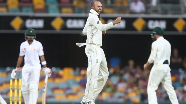 Cult hero: Nathan Lyon of Australia celebrates dismissing Babar Azam of Pakistan during day three of the First Test at the Gabba.