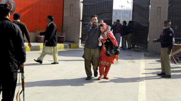 University staff leave the campus in Charsadda, Pakistan, after the attack on Wednesday.