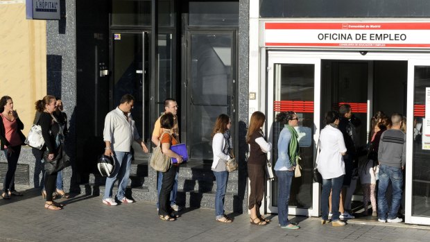 People queue at a government employment office in Madrid.