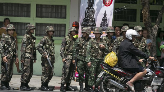 Thai soldiers patrol near government buildings last year after the army seized power. 