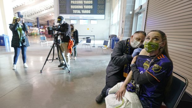 A sports fan gets vaccinated at Seattle's Lumen Field, prior to a soccer match in May.