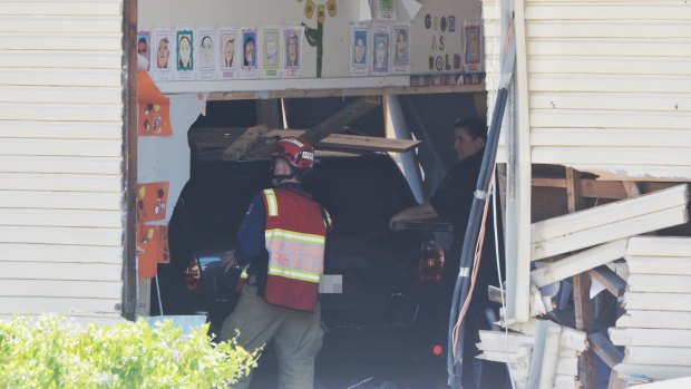 Emergency services personnel look into a classroom at Banksia Road Public School. Two boys, both aged eight, were killed and three other pupils injured after an SUV crashed into the room.