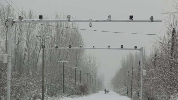Oppressive regime: surveillance cameras on the road entering the village of Pilal in Akto County, Xinjiang. 