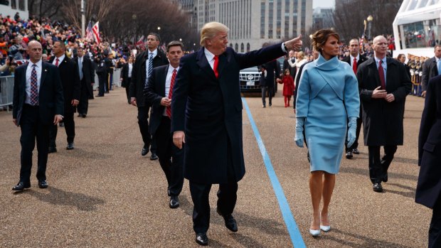 Donald Trump walks with first lady Melania Trump along the inauguration day parade route after being sworn in as the 45th President of the United States.