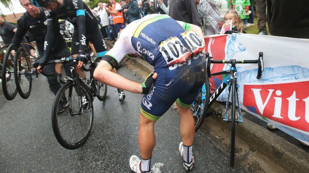 Michael Albasini picks himself up following a crash 25km from the finish during stage five.