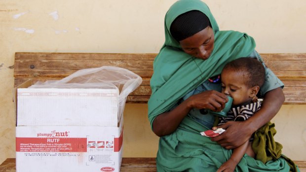 Two-year-old Seid eats high nutrient peanut paste provided by Save the Children's Health Extension Worker. 