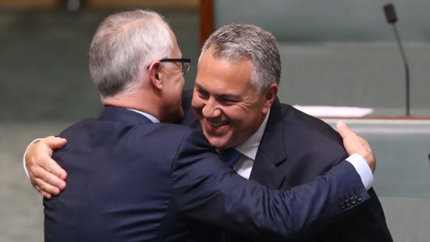 Prime Minister Malcolm Turnbull embraces former treasurer Joe Hockey after Mr Hockey's  valedictory speech. 