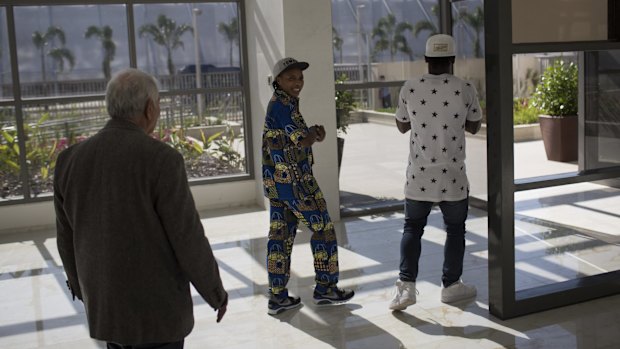 Refugees and judo athletes from the Democratic Republic of Congo Yolande Mabika, centre, and Popole Misenga, right, visit the Olympic Village on Wednesday.