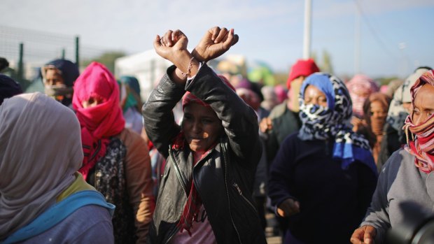 Women and children protest their case to the UK government at the notorious Jungle camp in Calais, France.