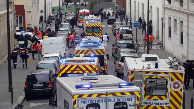 January 7, 2015: Ambulances gather in the street outside the French satirical newspaper Charlie Hebdo's office after masked gunmen stormed the newspaper, killing 12 people. 