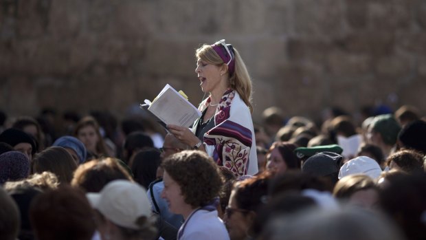 A Jewish woman risks arrest by wearing a prayer shawl while praying at the Western Wall in 2013.
