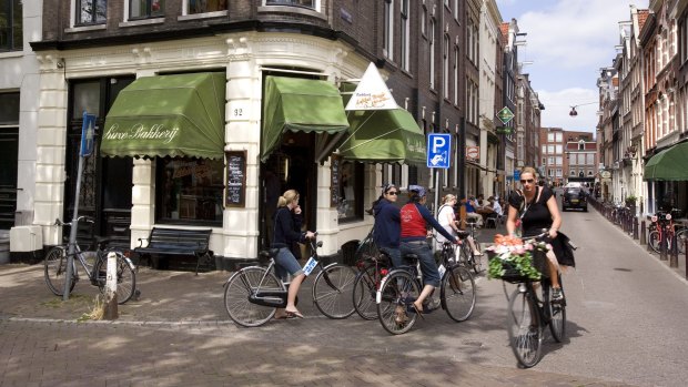 Feel the wind in your hair while you cycle in Amsterdam.
