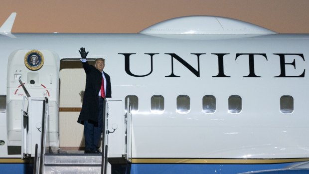 President Donald Trump waves as he boards Air Force One after speaking at a campaign rally in October.